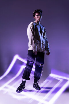 Man in neon stripes standing looking at camera