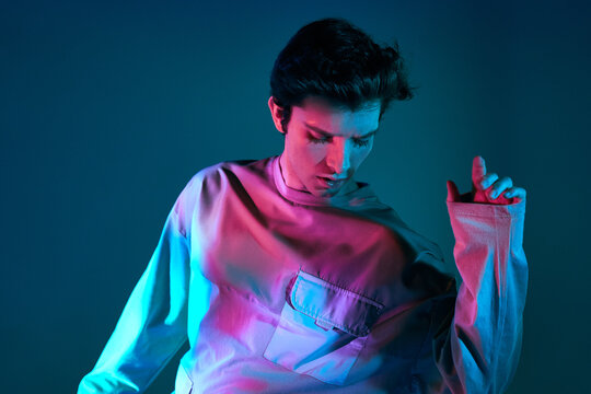 Modern man standing in neon lights