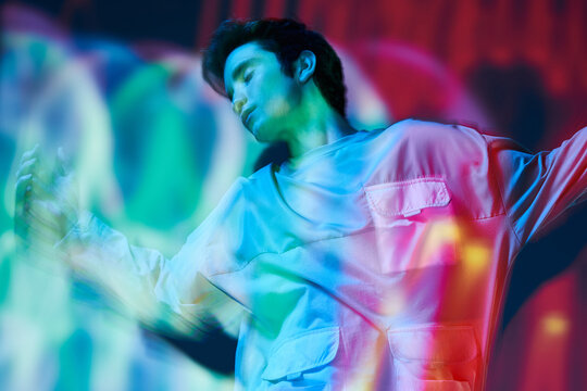 Modern man standing in neon lights