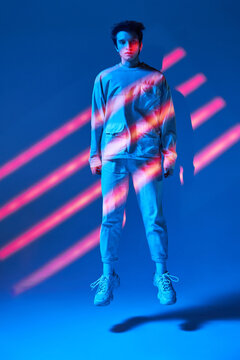 Man in neon stripes standing above ground