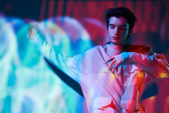 Modern man standing in neon lights