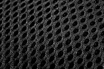 The texture of the mesh fabric in black color close-up. Grid