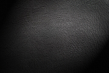 Black leather texture. Abstract background of dark leather with small roughness and scuffs