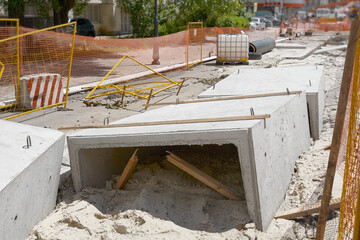 Concrete slabs ready for installation. Repair of waterways under the highway. Work area fencing.