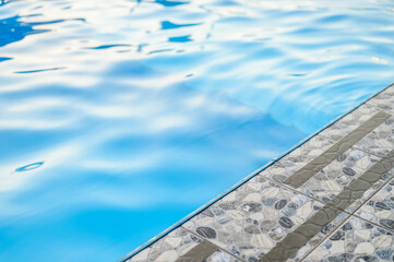 Tiles near the pool. Stone imitation. Swimming pool by the sea travel vacation in the park vacation background.