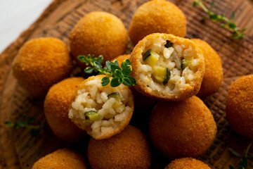 Recipe for arancini with zucchini in a small format similar to a Spanish tapa crequette.