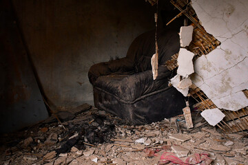 Old sofa in a destroyed building