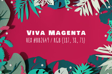 Viva Magenta color of the year 2023. Green exotic leaves on magenta background. Frame with text in the middle.