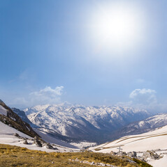 snowbound mountain pass at sunny day under sparkle sun