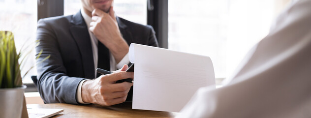 Asian young manager, employer man interview with person, have question about resume and listen to candidate answer, conversation together at office. Recruitment employee job concept.