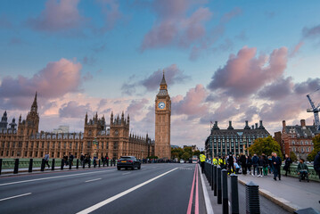 Fototapeta na wymiar Beautiful Westminster in London with people crossing the bridge. Amazing details after renovation of the Big Ben.