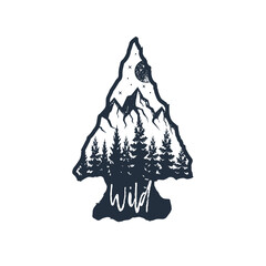 Hand drawn arrowhead textured vector illustration. Double exposure with pine forest, mountain range, night sky, and "Wild" lettering.