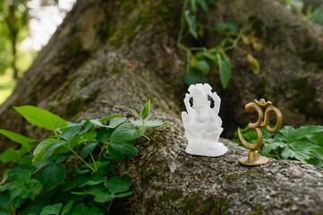 Figurine Trishakti Yantra and Ganesha for yoga and meditation on a natural background. OM-AUM.