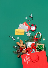 Holiday explosion from shopping bag on green background. Merry Christmas and Happy New Year concept