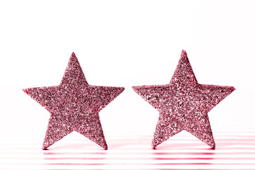 Textured glittering red stars on white background. Demonstrating Viva Magenta - trendy color of the year 2023
