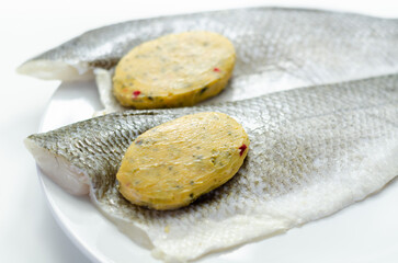 Prepared for fry boneless sea bass fillets with a lemon and pepper butter