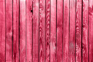 Light red wood plank wall texture background. Demonstrating Viva Magenta - trendy color of the year 2023