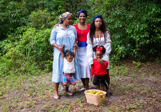 Women and children in park with produce basket