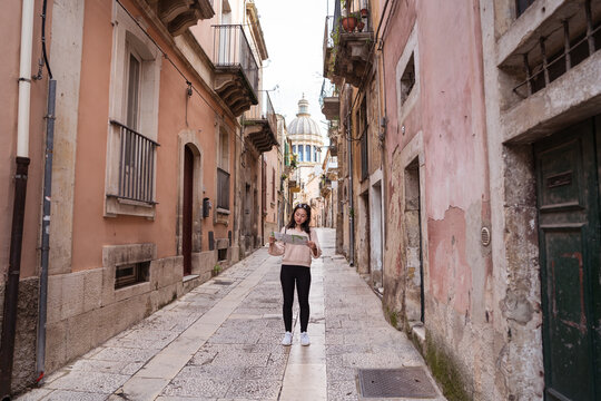 Asian tourist with map on street