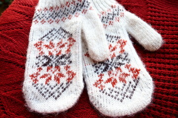 Fluffy white knitted mohair mittens with a traditional floral pattern on the back. A pair of...