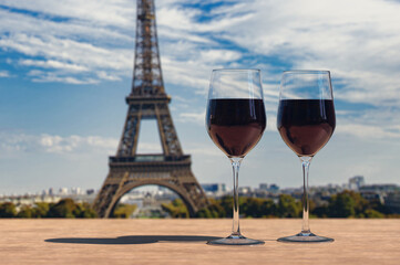 Two glasses of wine on Eiffel tower and Paris skyline background.