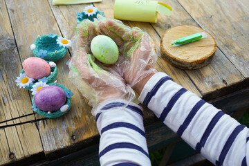 The day before Easter, close-up of children's hands painting eggs