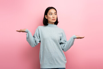 Portrait of uncertain confused girl in sweater expressing doubts and bewilderment