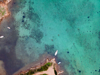 aerial view of the sea and the beach with rocks from a drone, Garibaldi bay on Caprera , la maddalena islands archipelago, Sardinia;