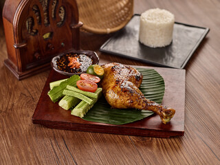 Ayam Bakar with Rice, chili sauce and salad served in dish isolated on table top view of thai food