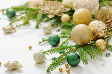 golden and green  christmas decorations  on white  background