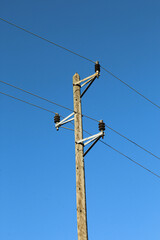 Wooden pole with power lines. Electricity transmission cables