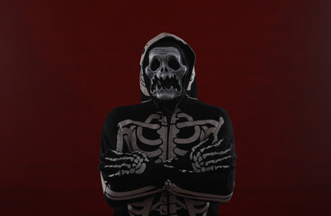 man in a skeleton mask on a red background