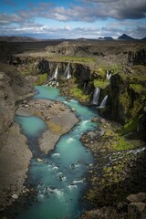 Vertical shot of the Sigoldugljufur canyon with the river and little springs in Iceland