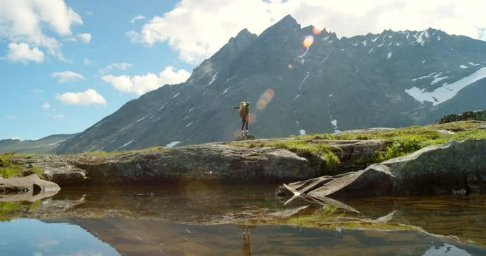 Woman, back and enjoying view of mountains, nature environment or countryside sustainability in Norway. Tourist, sightseeing or freedom in hiking location, travel or water lake for adventure holiday