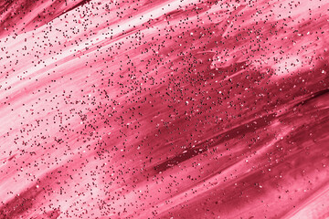 Glittering abstract painted background in magenta color.