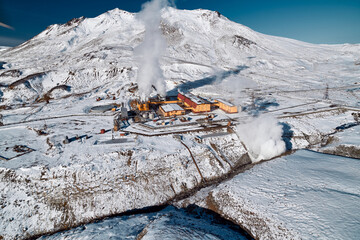 Aerial view to geothermal power plant in mountain. Clean green renewable energy in Kamchatka. - 550930030