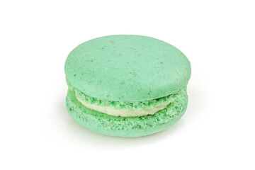 Single green macaroon with white filling cream isolated on white background. French macaron delicacy