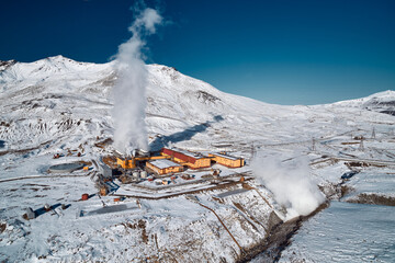 Aerial view to geothermal power plant in mountain. Clean green renewable energy in Kamchatka. - 550931286