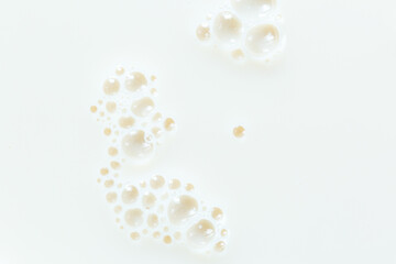 Macro milk texture,White surface of milk and bubbles and ripples from above birds eye view 