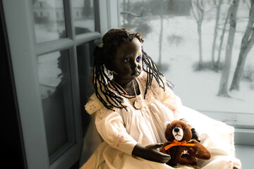 black doll with teddy bear