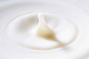 Macro milk drop,Drop on milk cream dairy product yoghurt milkshake texture swirl graphic design element for packaging flyer ad poster cream splash with ripple circle