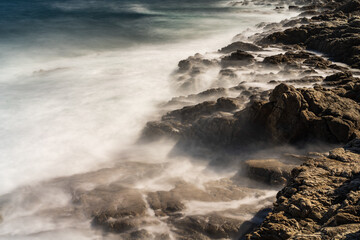 Flowing movements of the sea on the coast long exposure