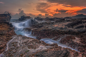 Fototapeta na wymiar Rock and waves at savarna beach, Indonesia