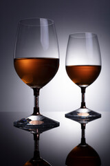 glasses with cognac on grey background