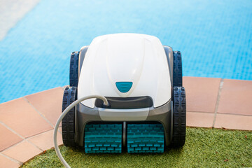 garden pool cleaner robot Pool cleaner robot out of the water at the edge. Automatic pool vacuum...