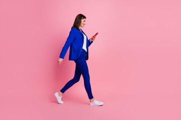 Fototapeta na wymiar Full length profile side photo of successful elegant stylish lady wear step empty space use modern gadget isolated on pink color background