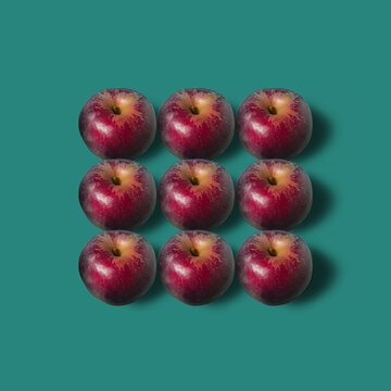 Fall pattern in red and dark green. Minimal frame background with ripe red apples with soft shadow.