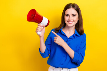 Photo of positive cheerful ukrainian lady wear blue stylish clothes arm direct empty space isolated on yellow color background