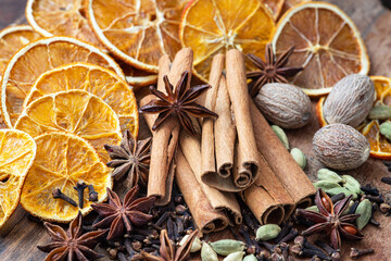 Mulled wine spice ingredients. On wooden background