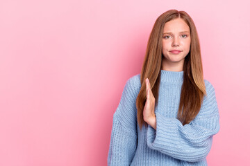 Photo of unhappy dissatisfied schoolgirl teenager wear blue sweater showing no symbol palm empty...